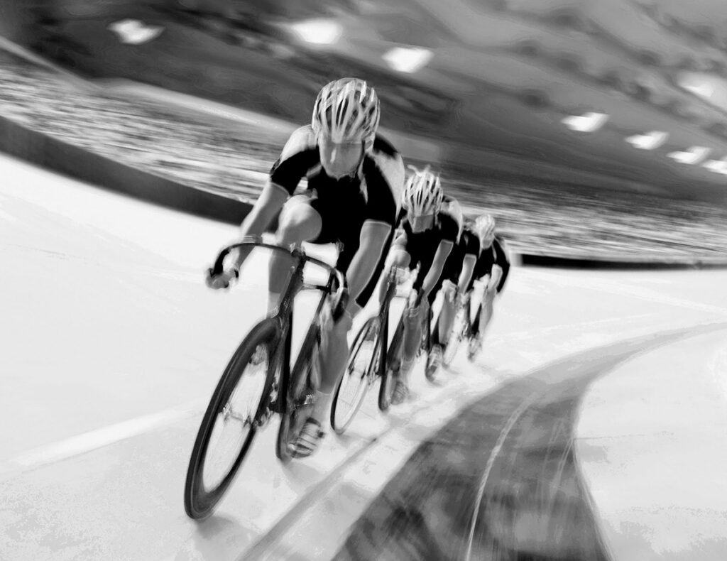 Cyclists in a row on a velodrome track